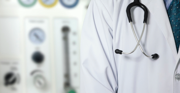 Doctor with stethoscope in medical setting.